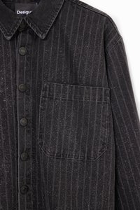 Black striped denim shirt with metallic flecks, featuring a collared neckline, seven buttons, and a patch pocket on the left side.