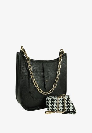 Black leather handbag with a textured finish, featuring a gold chain strap and a detachable black and white houndstooth patterned strap.