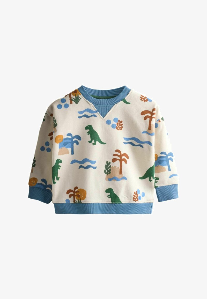 Bluză crem cu mâneci lungi pentru copii, cu manșete și guler albaștri, având un model cu dinozauri verzi, palmieri și valuri albastre.