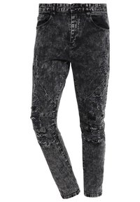 Czarne dżinsy denimowe o postrzępionym wzorze, z przetarciami, slim fit i klasycznym pięcioma kieszeniami.