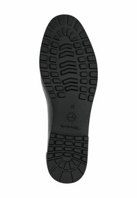 La suela de goma negra presenta un patrón texturizado y estriado para mayor tracción, con un borde liso y el logotipo de la marca grabado cerca del talón. Talla 37.