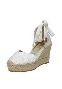 Scarpa espadrillia bianca con zeppa intrecciata, punta chiusa, suola in juta e lacci in tessuto alla caviglia, caratterizzata da una texture liscia e una finitura naturale.