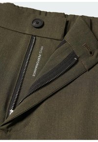 Olive green pants featuring a zipper fly, button closure, and integrated elastic waistband with a flat texture. Logo visible on the inside.
