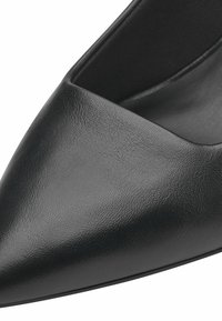 Black leather pointed-toe pump with a textured finish and a low-cut design. The inner lining is smooth, complementing the exterior material.