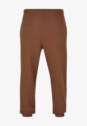 Pantaloni della tuta marroni con una texture morbida, vita elastica e polsini. Presentano tasche laterali e un design semplice e dritto.