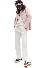 Light pink buttoned jacket, white striped shirt, white pants, black and white checkered visor, and black sneakers with white accents.