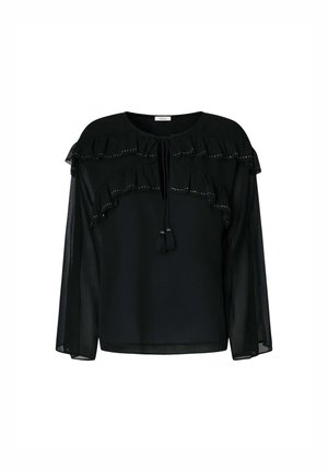 Blusa negra con mangas largas transparentes, frontales con volantes y tachuelas decorativas. Presenta un cierre con lazo y borlas en el escote.