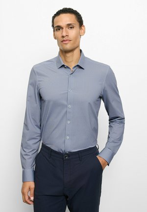 Hellblaues Hemd mit Knöpfen, kleinem Karomuster, langen Ärmeln und spitzem Kragen, kombiniert mit dunkler Hose.