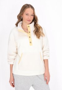 Witte fleece pullover met gele accenten, een halflange knopenrij en een voorzak. Beschikt over een zachte, gestructureerde stof en een ontspannen pasvorm.