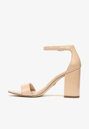 Beige lakleren sandalen met hakken, voorzien van een brede teenstrand en een blokhak. Heeft een enkelbandje en een gladde glanzende textuur.