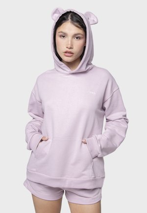 Sudadera de color púrpura claro con orejas de oso, puños acanalados y bolsillos frontales. Elaborada en material suave, con un corte casual y logotipo bordado.