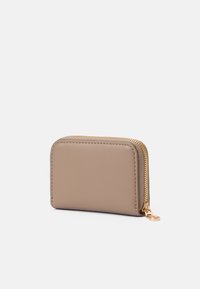 Beżowy skórzany portfel o prostokątnym kształcie, z złotym zamkiem błyskawicznym i gładką teksturą; charakteryzuje się minimalistycznym stylem bez dodatkowych wzorów.