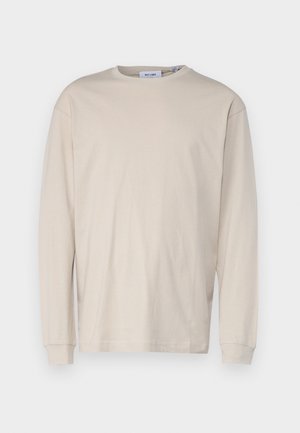 Light beige long-sleeve T-shirt made of soft cotton, featuring a round neckline, relaxed fit, and ribbed cuffs. No visible patterns or graphics.