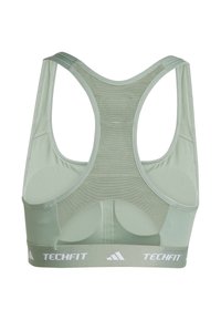 Sujetador deportivo verde menta con espalda de malla, tirantes anchos y una banda elástica blanca con la marca "TECHFIT". Tejido suave y elástico.