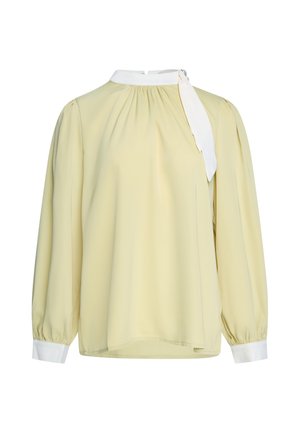Long-sleeve pale yellow blouse with white cuffs, white high neck, and an asymmetrical white necktie detail on the right side.