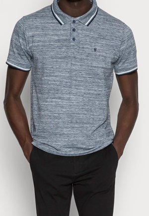 Navy blue polo shirt with a textured pattern, three buttons, and contrasting collar and sleeve trims. Worn with black trousers.