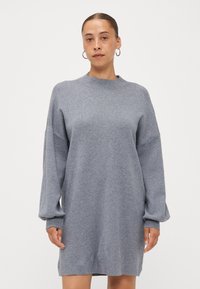 Grey knitted dress with long, loose sleeves and a high neckline. Soft texture, above-the-knee length, and subtle ribbing details.