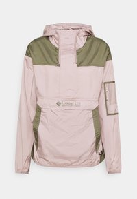 Veste Columbia Sportswear rose clair et vert olive avec capuche, poche à rabat avant et poche zippée en mesh sur la manche gauche.