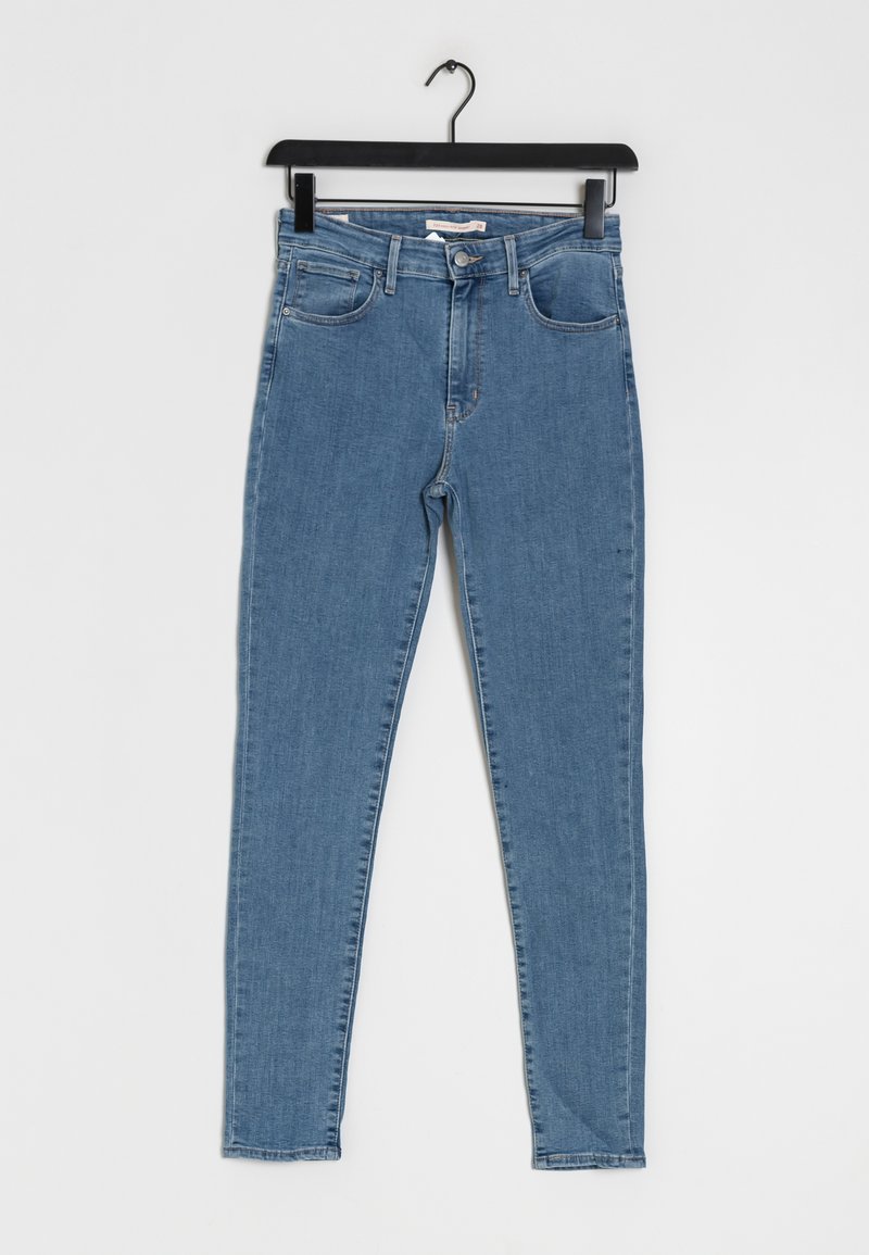 Siniset farkut, joissa on kapea malli ja korkea vyötärö, viisi taskua ja sileä pinta. Hieman haalistumista reiden ja helman kohdalla.