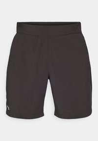Sorte shorts laget av lett materiale med en glattere tekstur, med elastisk midjebånd og en liten farget logo nederst til venstre.
