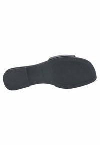 Black flat sandal sole, textured rubber with horizontal and vertical grooves for grip. "NINE WEST" logo embossed near the heel.