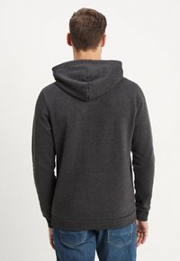 Donkergrijze hoodie met een trekkoordkap, ribgebreide manchetten en zoom. Zachte textuur, met een schoon, minimalistisch ontwerp.