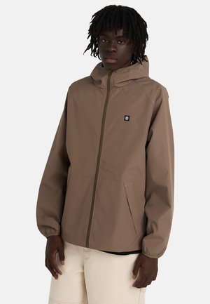 Brązowa kurtka na zamek z kapturem, wykonana z gładkiej tkaniny. Posiada logo na piersi i dwie boczne kieszenie. Luźny krój.