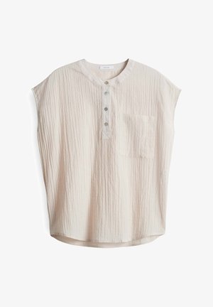 Blusa corta beige chiaro a maniche corte con scollo rotondo, chiusura frontale con bottoni e taschino sul petto, realizzata in tessuto stropicciato testurizzato.