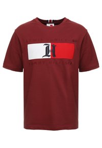 Red cotton t-shirt featuring a white and red rectangular graphic with "LEWIS HAMILTON" and a black "H" logo, short sleeves, crew neckline.