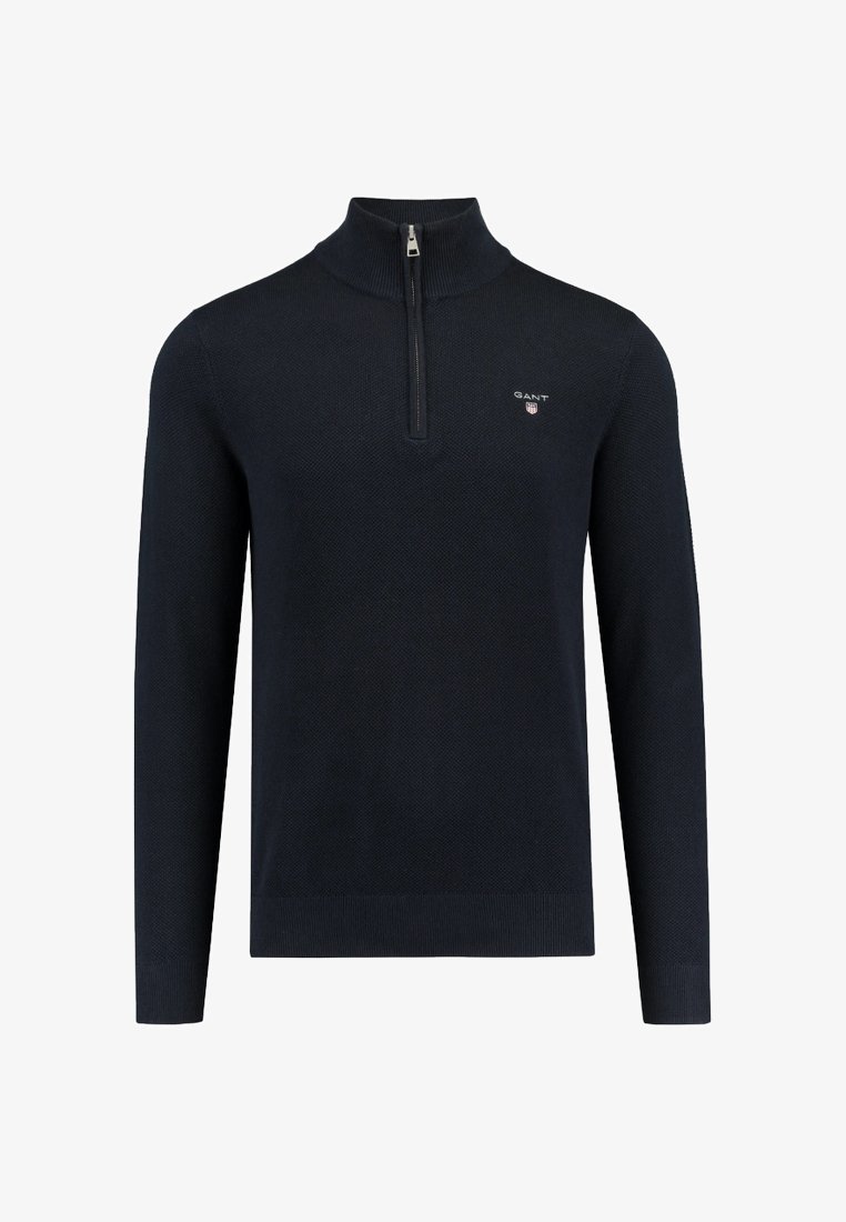Dunkelblauer Pullover mit langen Ärmeln, hohem Kragen, halber Reißverschluss, strukturiertem Stoff und kleinem gesticktem Logo auf der Brust.