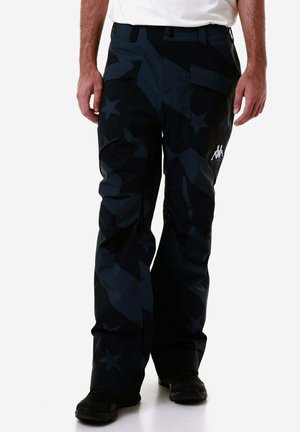 Pantaloni da neve neri con un motivo geometrico a stelle, caratterizzati da una vestibilità rilassata, tasche con zip e un accento con logo sulla coscia sinistra.