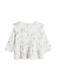 Top blanco de manga larga con estampado floral, volantes en los hombros y dobladillo con peplum. Hecho de tela suave con un diseño acanalado texturizado.