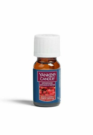 Kleine amberen glazen fles met witte dop, gelabeld Yankee Candle Black Cherry diffuserblend, 10 ml, met kersen afgebeeld op het etiket.