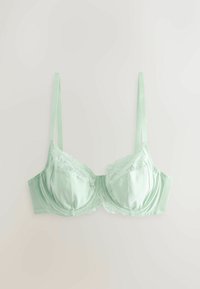 Soutien-gorge en satin vert clair et dentelle avec bretelles fines réglables et bonnets à armatures, posé à plat sur un fond blanc.