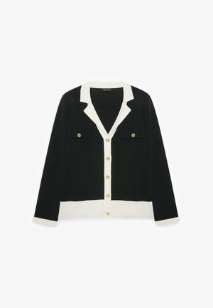 Černý kardigan s bílým límcem, manžetami a lemem, zdobený zlatými knoflíky vpředu a na dvou náprsních kapsách.