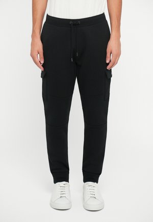 Black cargo joggers with a drawstring waistband, side pockets, and ribbed cuffs. Made from soft fabric with a smooth texture.