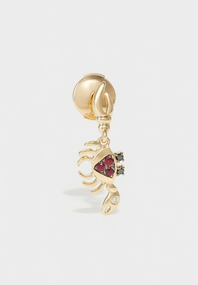 Gold scorpion earring with red and black gemstone accents; detailed claws and a textured body; secured with a round backing.