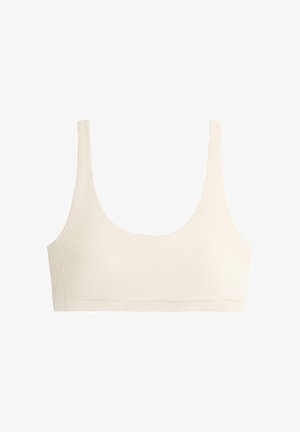 Krém színű, varrás nélküli melltartó széles vállpántokkal és texturált, átlós bordázott mintával, kényelmet és könnyű tartást biztosítva.