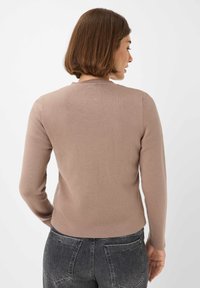 Beige knitted sweater with long sleeves, round neck, and a slight texture. The back features a clean design with no embellishments.