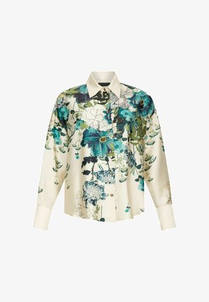 Chemise à motifs floraux crème, avec des fleurs bleues et vertes, manches longues, col pointu et fermeture à boutons. Matière semblable à de la soie.