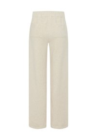 Helle beige weit geschnittene Hose mit einem elastischen Bund und zwei Gesäßtaschen, aus strukturiertem Stoff mit sichtbaren Nähten und einer lässigen Passform.