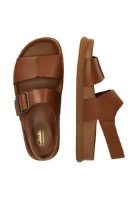 Ruske nahkakepid, millel on kaks laia rihma, millest üks sisaldab metallist pandlat. Pehme sisetald ja kummist tallad, kerge kontsapadi.