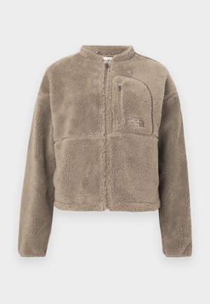 Taupe-colored fleece jacket with full front zipper, zippered chest pocket, and embroidered The North Face logo on chest.