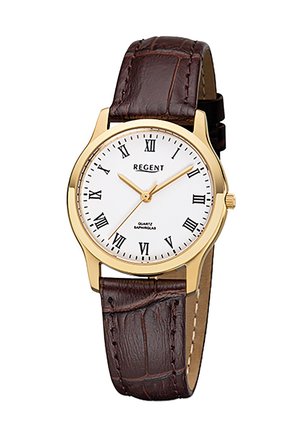 Montre en quartz dorée avec un cadran blanc, des chiffres romains et un bracelet en cuir brun à motif crocodile. Elle est dotée d'un verre en saphir.