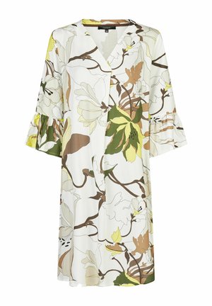 Bloemenjurk met een witte achtergrond en groene, bruine en gele botanische print. V-hals, uitlopende mouwen met ruches.