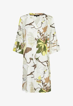 Bloemenjurk met een witte achtergrond en groene, bruine en gele botanische print. V-hals, uitlopende mouwen met ruches.