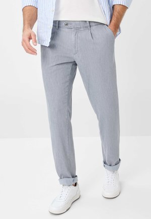 Gray streamlined pants with a subtle pattern, tapered fit, rolled cuffs, and a button closure, paired with white sneakers.