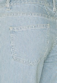 Light blue striped denim fabric, featuring a back pocket with a straight edge. The stripes are narrow and evenly spaced.