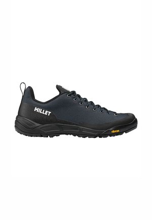 Black and dark blue low-cut hiking shoe with laces, "MILLET" logo on side, and Vibram sole, shown in side profile on white background.
