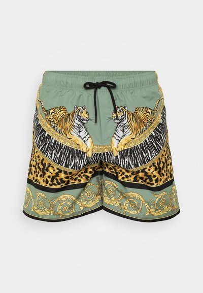 Rohelised lühikesed püksid, millel on tiigri- ja loomade mustri disain. Eesmised mustad nöörid, kuldsed aksessuaarid ja tekstuuriline muster allääres.